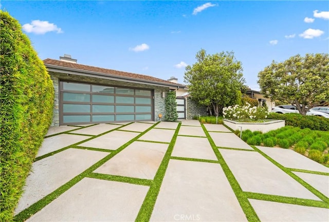 9 Jasmine Creek Dr, Corona Del Mar, CA 92625 - view of front facade with stone siding, a garage, and a chimney