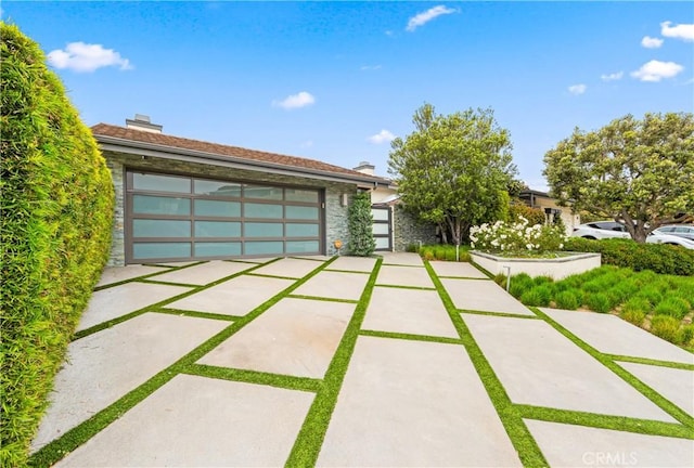 9 Jasmine Creek Dr, Corona Del Mar, CA 92625 - view of front of house featuring stone siding, a garage, and a chimney