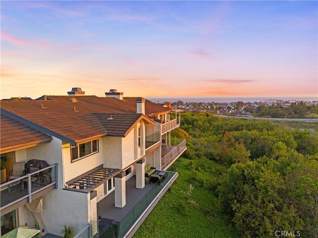 9 Jasmine Creek Dr, Corona Del Mar, CA 92625 - back of house with stucco siding, roof with shingles, and a balcony