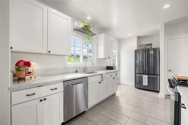 521 N Vine St, Anaheim, CA 92805 - kitchen featuring appliances with stainless steel finishes, a sink, white cabinets, recessed lighting, and light stone counters