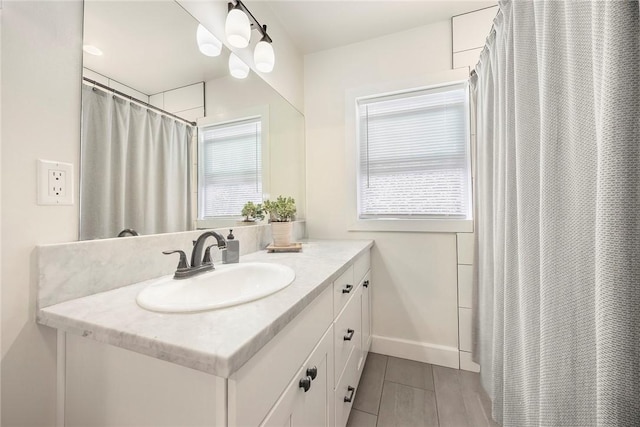 521 N Vine St, Anaheim, CA 92805 - full bathroom featuring vanity, baseboards, and a shower with shower curtain