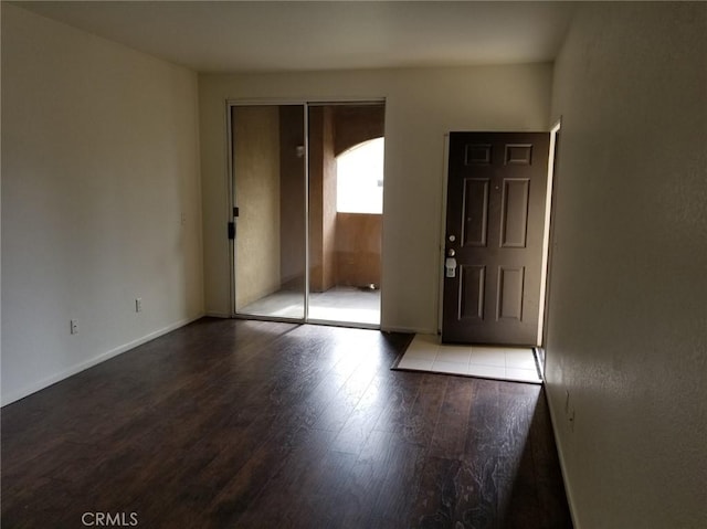 interior space with wood finished floors and baseboards