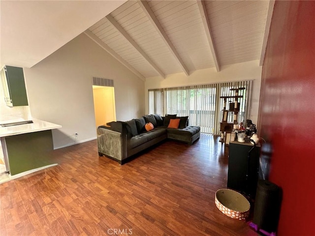 living area featuring beam ceiling, wood finished floors, high vaulted ceiling, visible vents, and baseboards
