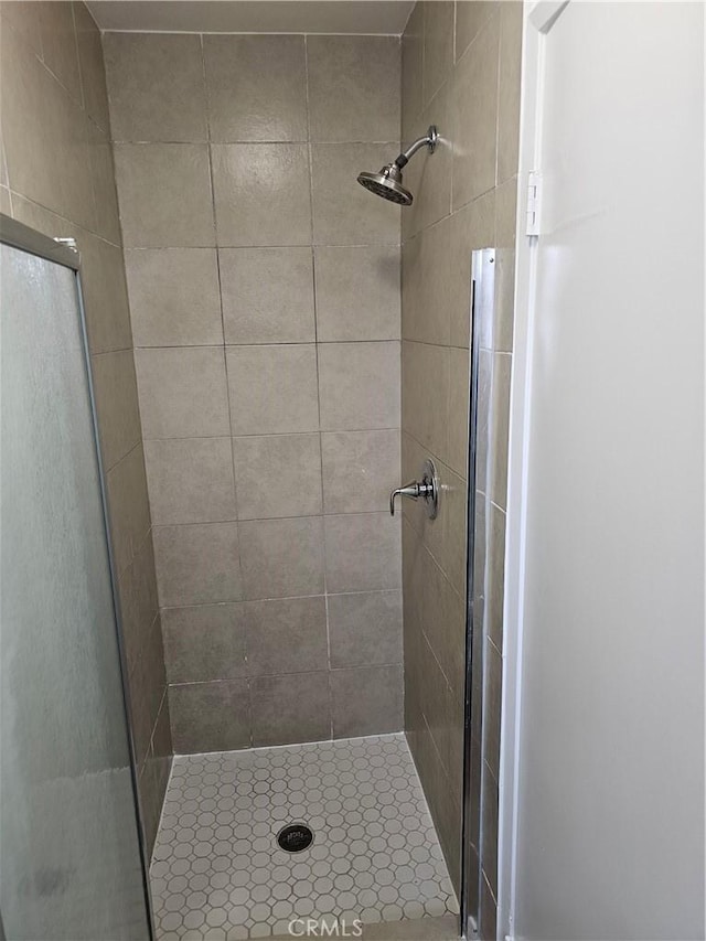 full bath with a shower stall