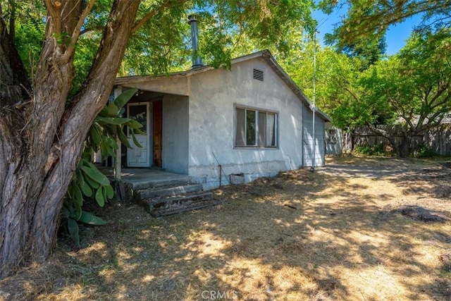 5985 Dolores Ave, Atascadero, CA 93422 - rear view of house featuring fence, stucco siding, and crawl space