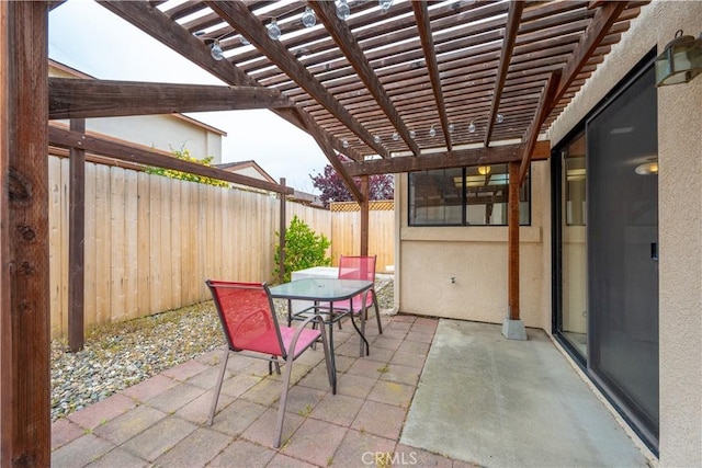 view of patio / terrace featuring outdoor dining area, a pergola, and a fenced backyard