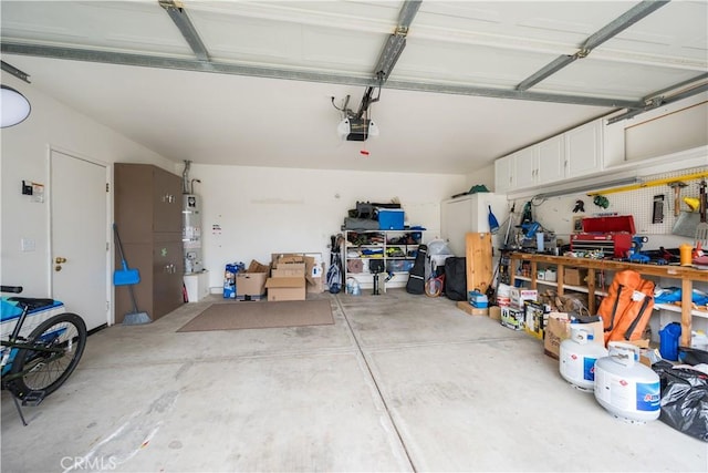garage with water heater and a garage door opener
