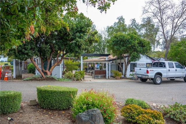 view of home's community featuring fence