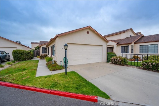 ranch-style house featuring fence, an attached garage, stucco siding, and driveway