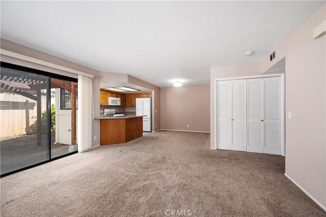 unfurnished living room with light colored carpet, baseboards, and visible vents