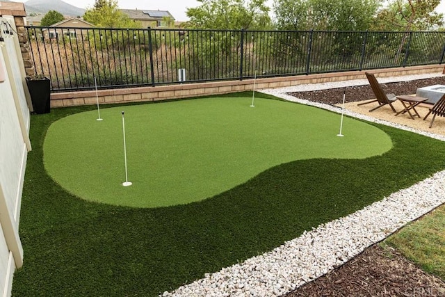 surrounding community with a putting green and fence