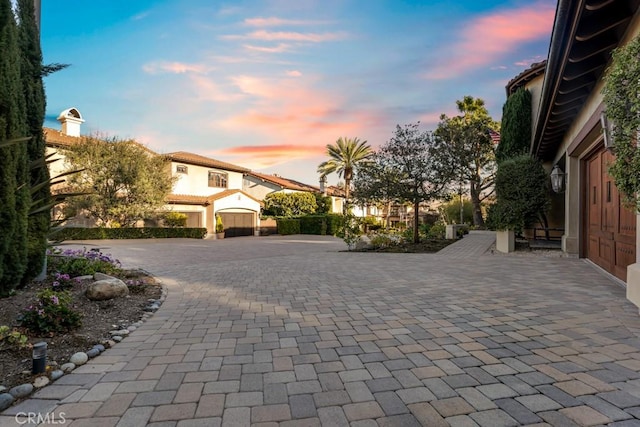 view of front of property with a patio area, stucco siding, and decorative driveway