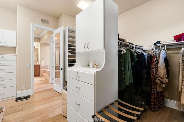 spacious closet featuring light wood finished floors and visible vents