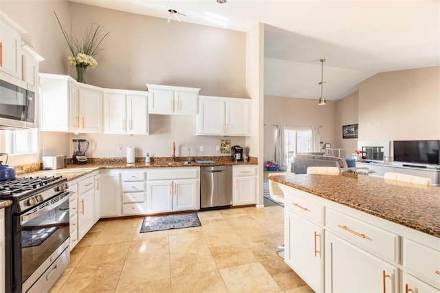 kitchen featuring stone countertops, white cabinetry, and stainless steel appliances
