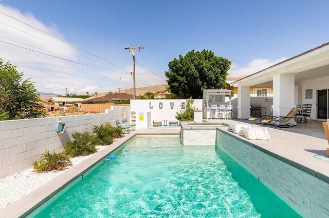 view of swimming pool with a patio, a fenced in pool, and a fenced backyard
