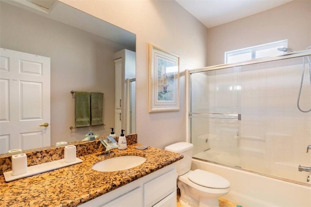 full bathroom featuring toilet, vanity, and enclosed tub / shower combo