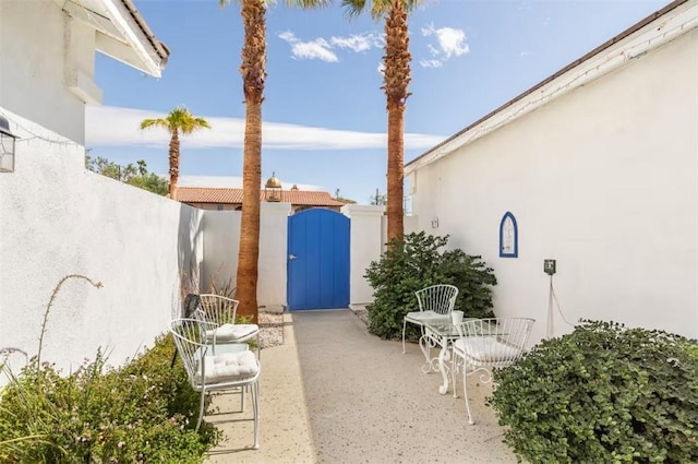 view of patio / terrace featuring fence and a gate