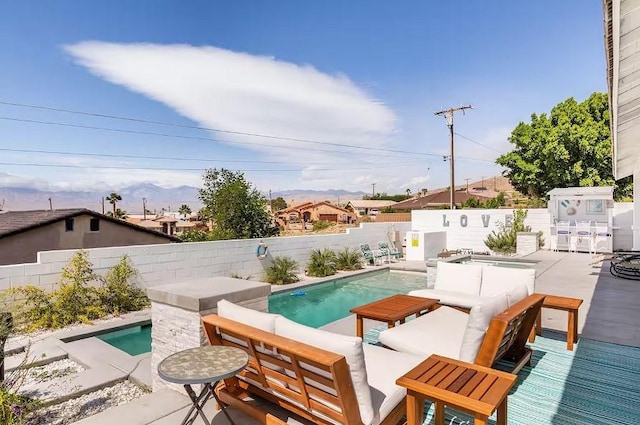 view of pool featuring an outdoor hangout area, a mountain view, a fenced in pool, and a fenced backyard