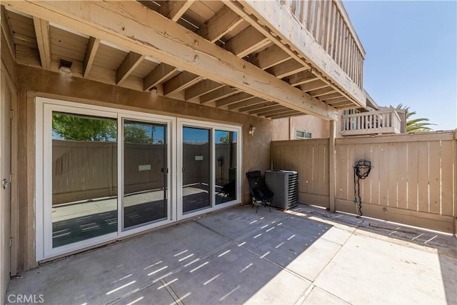 view of patio / terrace featuring central air condition unit and fence