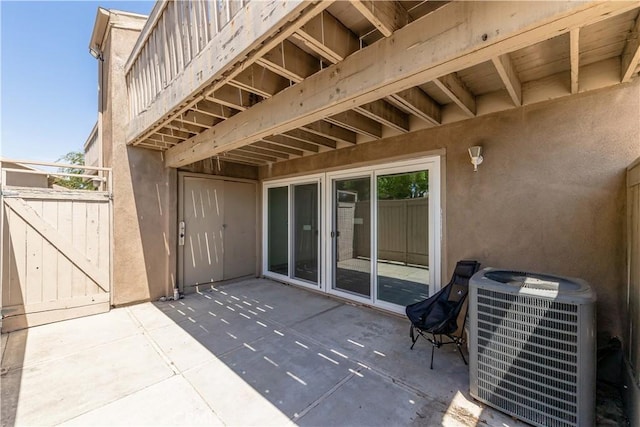 view of patio / terrace with cooling unit and a gate
