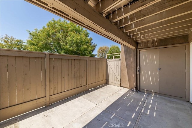view of patio / terrace featuring fence and a gate