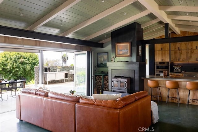 living area with a wood stove, wood ceiling, and lofted ceiling with beams