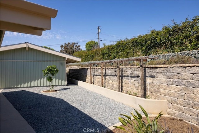 view of yard featuring fence and a patio