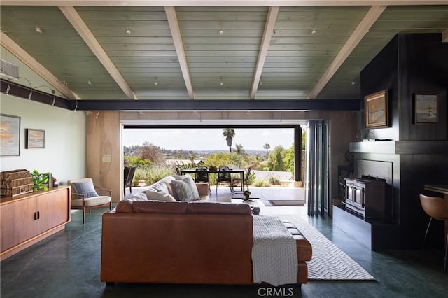 living area featuring wood ceiling, concrete flooring, and vaulted ceiling with beams