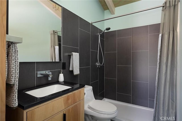 bathroom with toilet, tiled shower, vanity, and beam ceiling