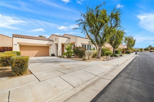 79260 Cool Reflection Ln, Quinta, CA 92253 - mediterranean / spanish-style house featuring an attached garage, driveway, stucco siding, and a tile roof
