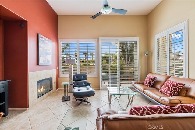 79260 Cool Reflection Ln, Quinta, CA 92253 - living room with a tile fireplace, a ceiling fan, light tile patterned floors, and baseboards