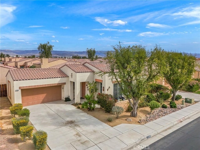 79260 Cool Reflection Ln, Quinta, CA 92253 - mediterranean / spanish home featuring stucco siding, an attached garage, driveway, and a tile roof