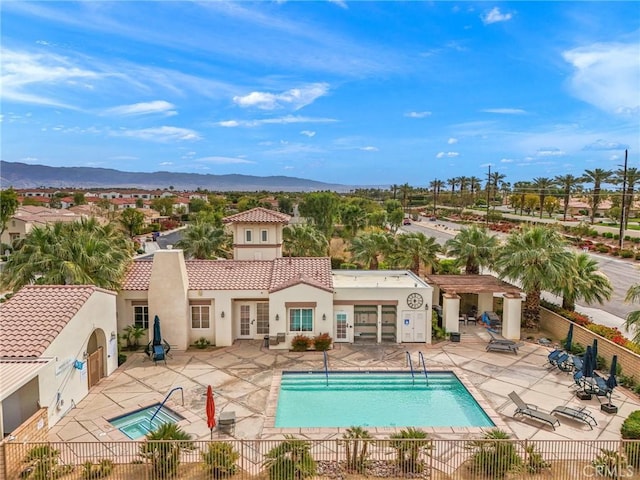 79260 Cool Reflection Ln, Quinta, CA 92253 - community pool featuring french doors, fence, a mountain view, and a patio