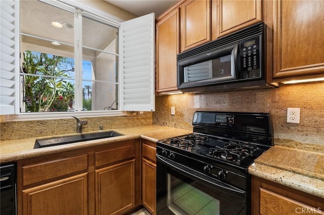 79260 Cool Reflection Ln, Quinta, CA 92253 - kitchen with black appliances, a sink, tasteful backsplash, and brown cabinetry