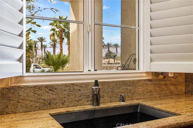 79260 Cool Reflection Ln, Quinta, CA 92253 - kitchen view of a sink, backsplash, and light stone counters