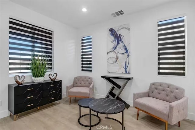 sitting room with baseboards, visible vents, and recessed lighting
