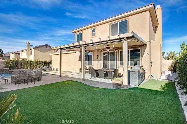 back of property featuring a lawn, fence, a patio, ceiling fan, and stucco siding