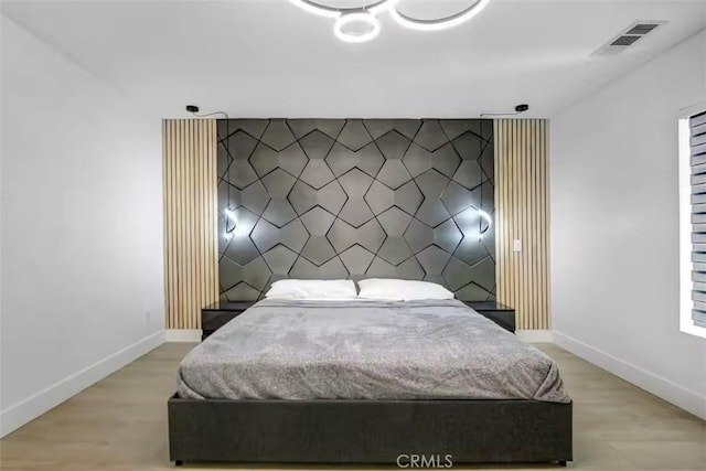 bedroom with baseboards and visible vents