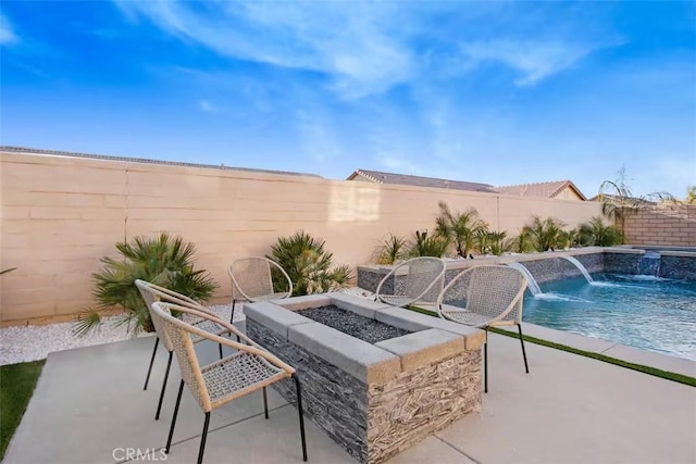 view of patio / terrace featuring a fenced backyard, an outdoor fire pit, and a fenced in pool