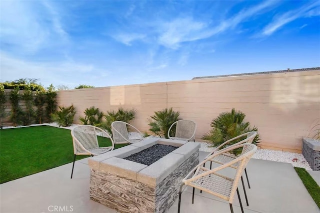 view of patio / terrace featuring an outdoor fire pit and a fenced backyard
