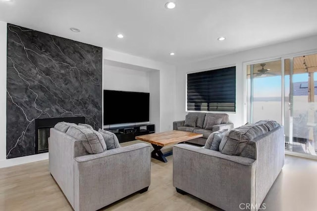 living area with recessed lighting and an accent wall