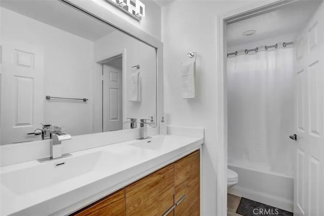 bathroom with toilet, shower / tub combo, double vanity, and a sink