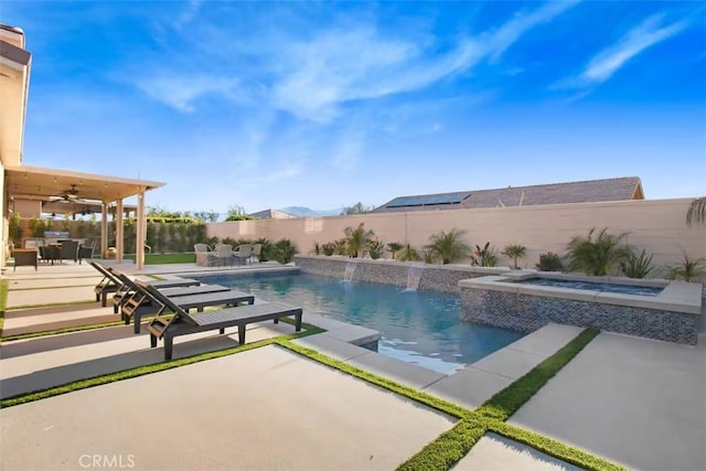 view of pool with an in ground hot tub, a ceiling fan, a fenced backyard, a patio area, and a fenced in pool