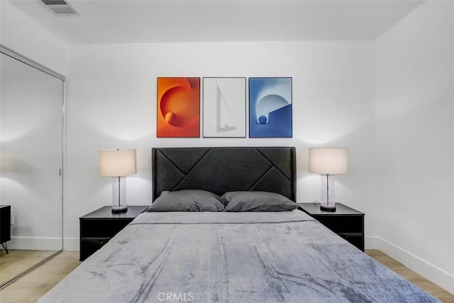bedroom with baseboards and visible vents