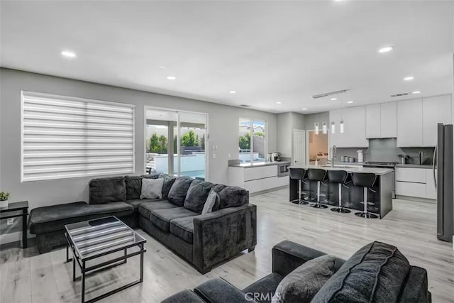 43118 Fiore St, Indio, CA 92203 - living room featuring light wood-type flooring, visible vents, and recessed lighting