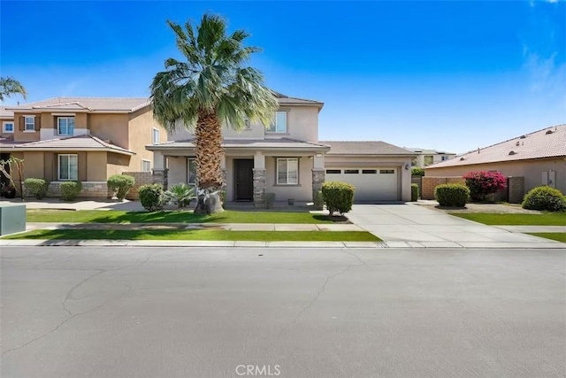 43118 Fiore St, Indio, CA 92203 - view of front of house featuring an attached garage, stucco siding, driveway, and a front yard