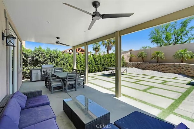 43118 Fiore St, Indio, CA 92203 - view of patio with a ceiling fan, area for grilling, outdoor dining area, a fenced backyard, and an outdoor living space