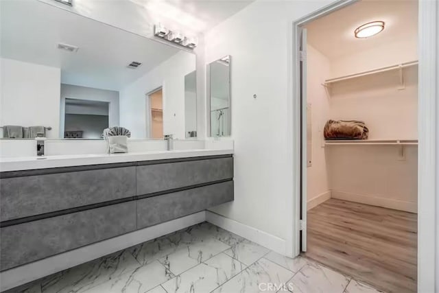 43118 Fiore St, Indio, CA 92203 - full bathroom featuring double vanity, a spacious closet, baseboards, and visible vents