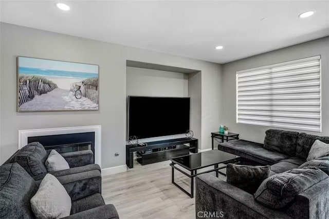 43118 Fiore St, Indio, CA 92203 - living room with light wood-style floors, baseboards, a glass covered fireplace, and recessed lighting