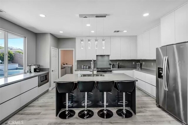 43118 Fiore St, Indio, CA 92203 - kitchen featuring modern cabinets, stainless steel appliances, washing machine and dryer, and recessed lighting